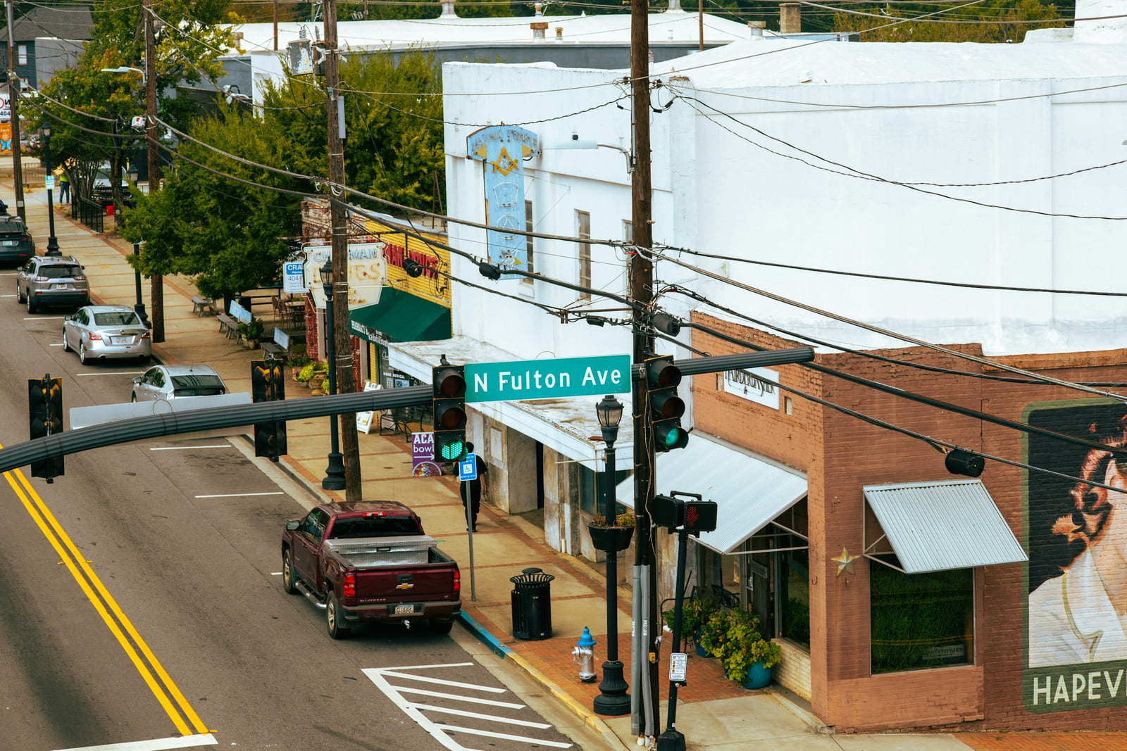 An Atlanta street corner with local businesses, brick buildings and overhead utility lines.