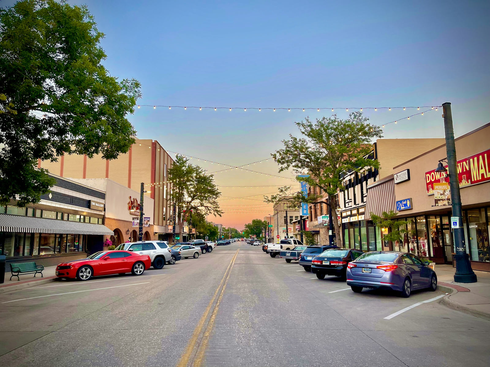 Storefronts and parked cars along a downtown street in Cheyenne, Wyoming.