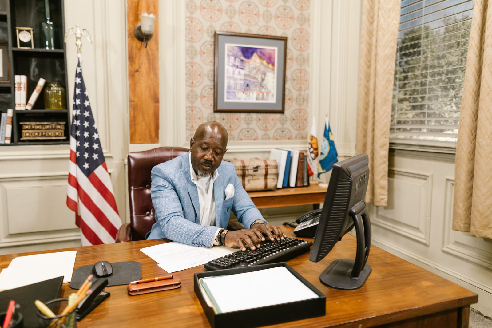 An attorney working at a computer behind an office desk.