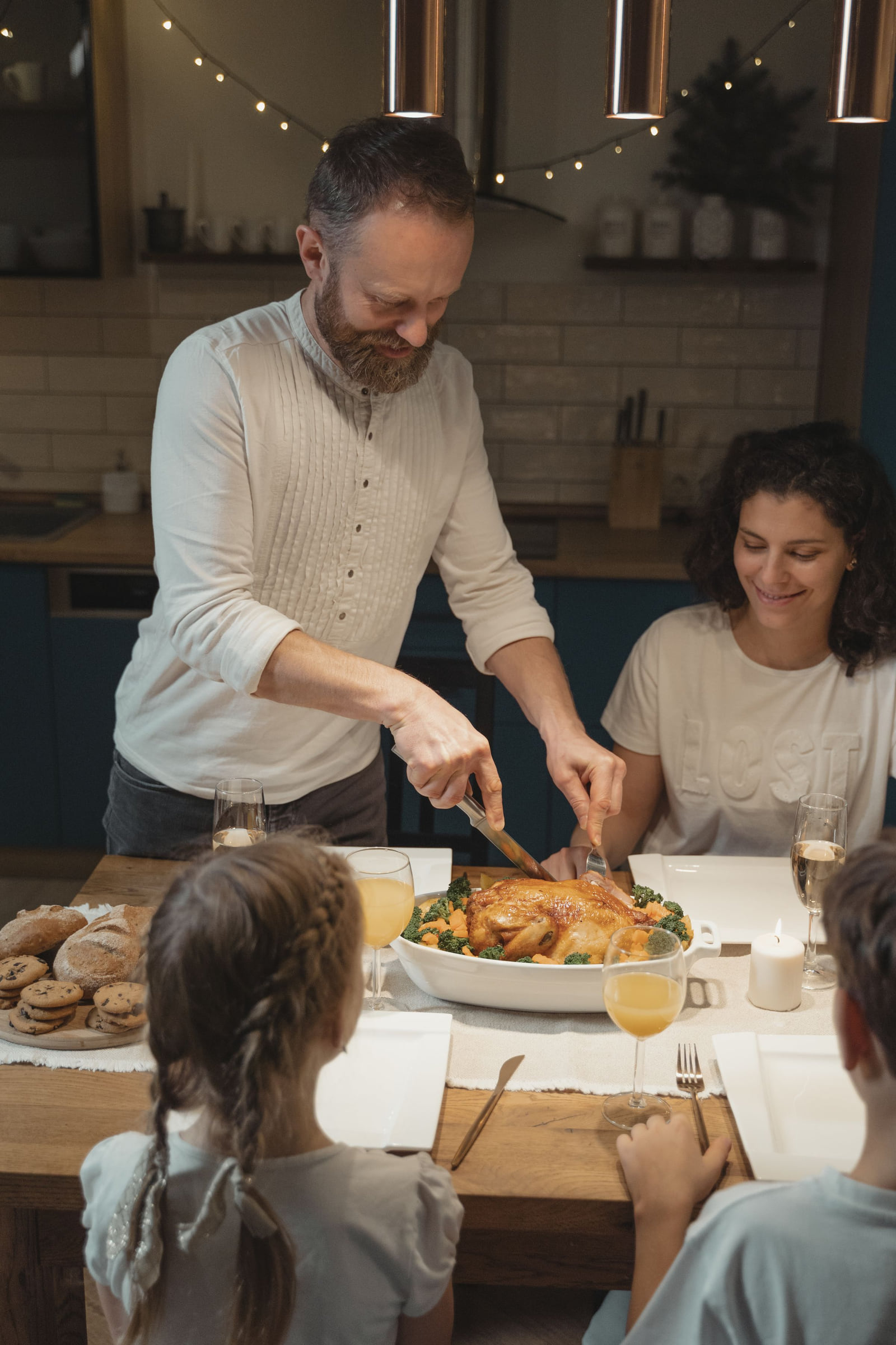 A family sharing a meal around a holiday dinner table.