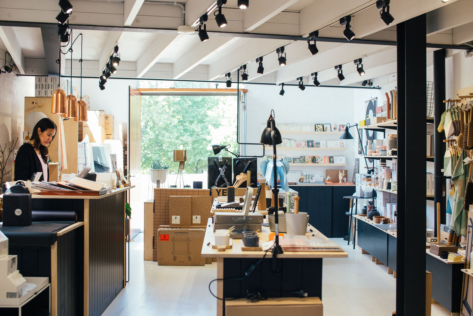 A bright independent shop with shelves of gifts and homewares.