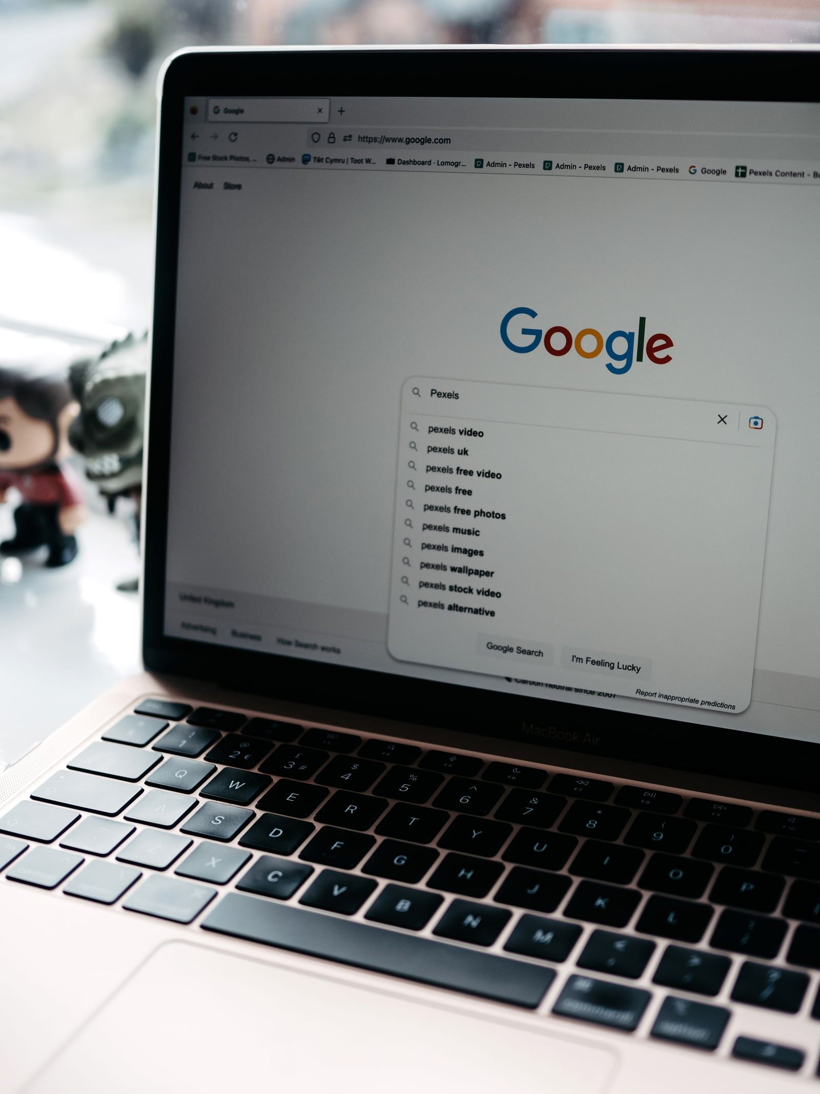 A laptop displaying Google's search box and suggested searches.