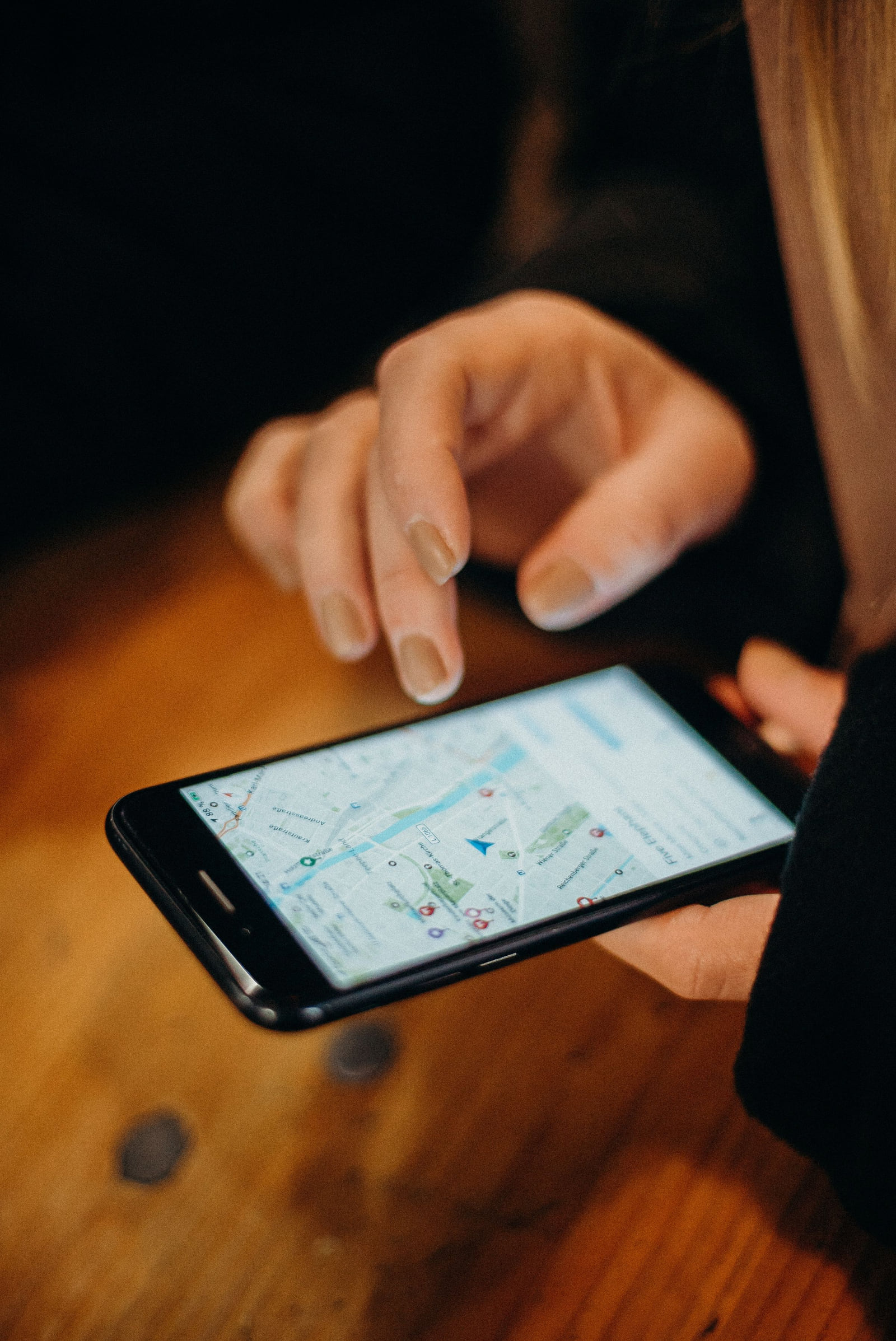 A person tapping a map on a smartphone.