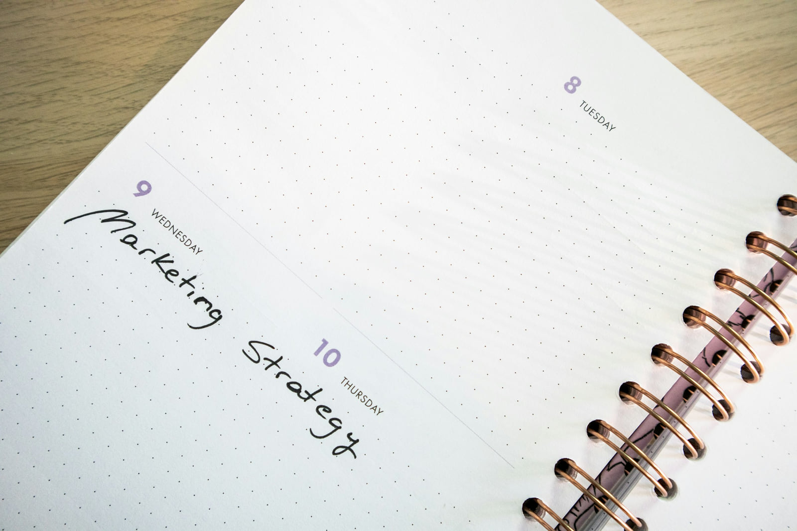 An open planner with Marketing Strategy handwritten across the page.