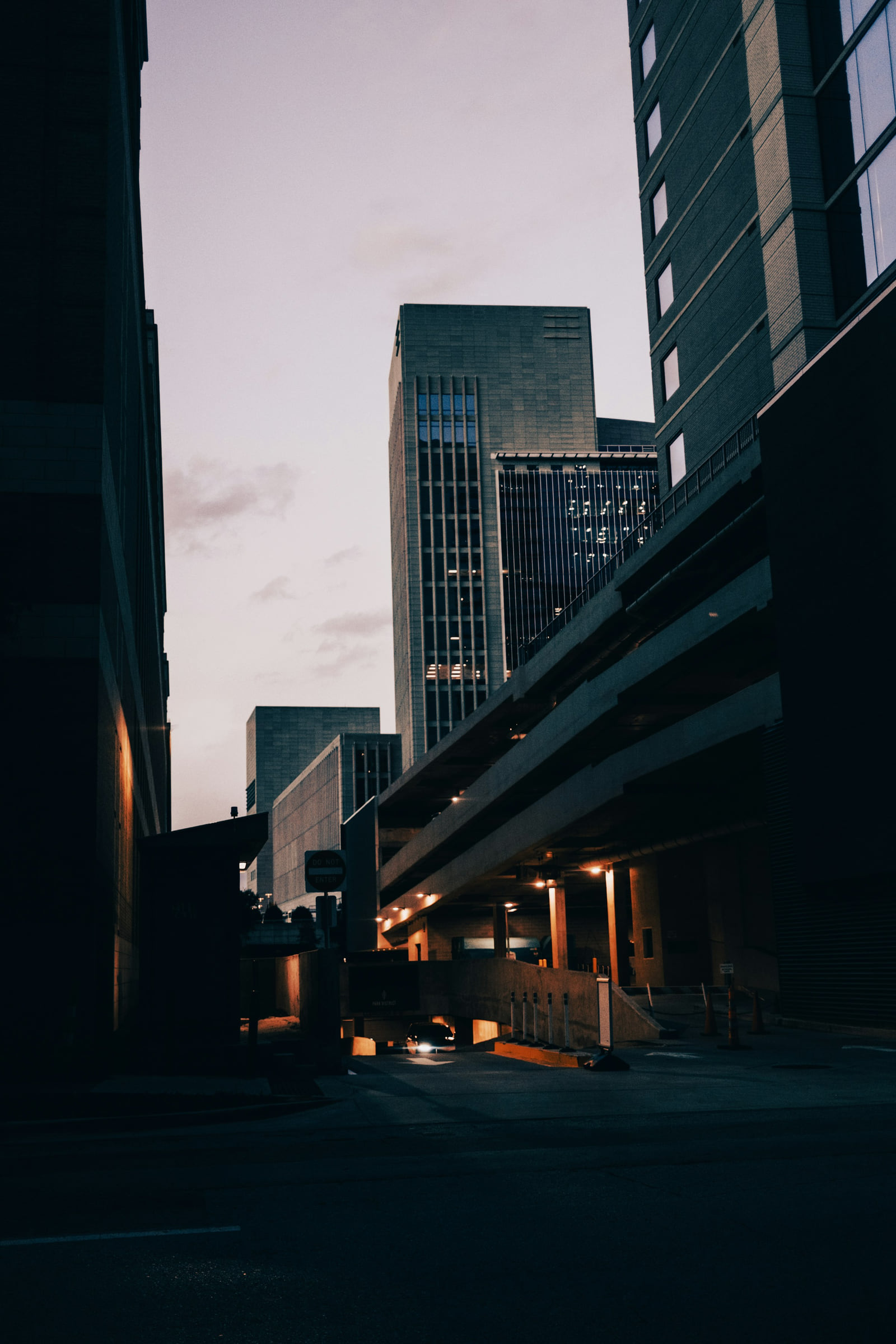 Downtown Dallas buildings viewed from beneath an elevated roadway.