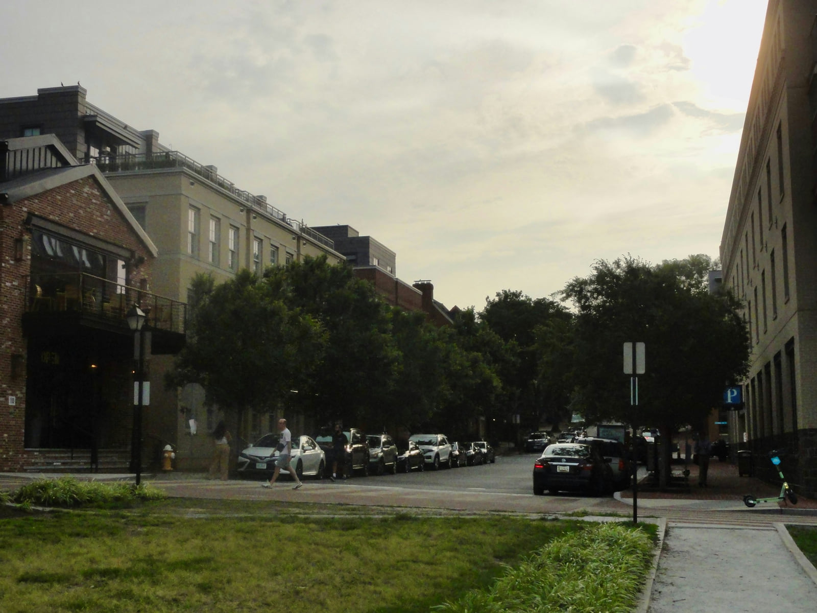 Brick buildings, trees and parked cars in Old Town Alexandria, Virginia.