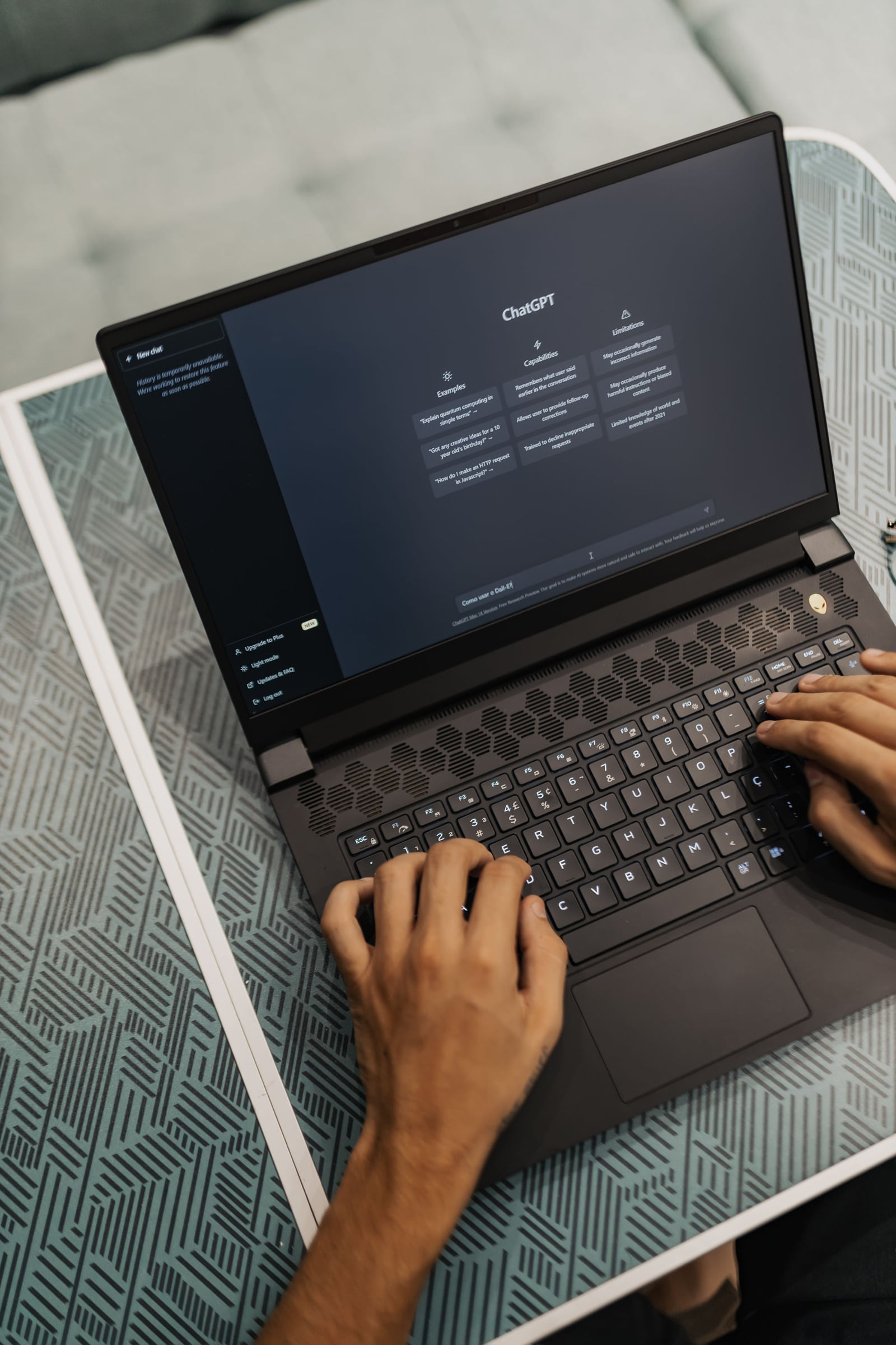 An overhead view of a person using ChatGPT on a laptop.