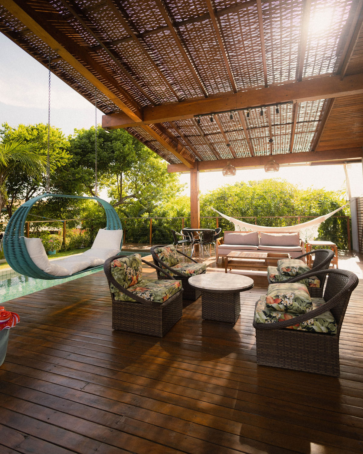 A furnished covered patio with polished wooden deck boards.