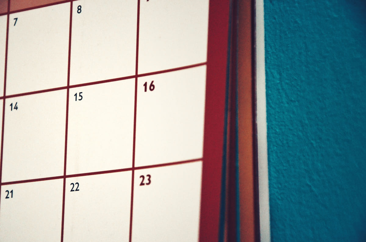 A close-up of a wall calendar with large date boxes.
