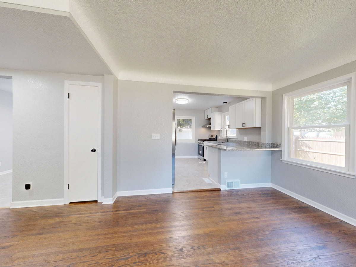 A light-filled home interior with newly finished wooden flooring.