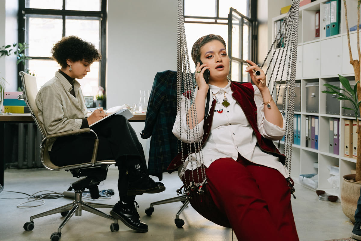 An office worker answering a phone beside rows of document folders.
