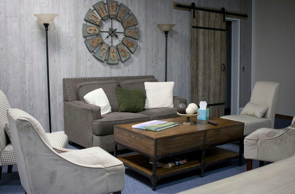 A calm seating area with a sofa, armchairs and a low table.