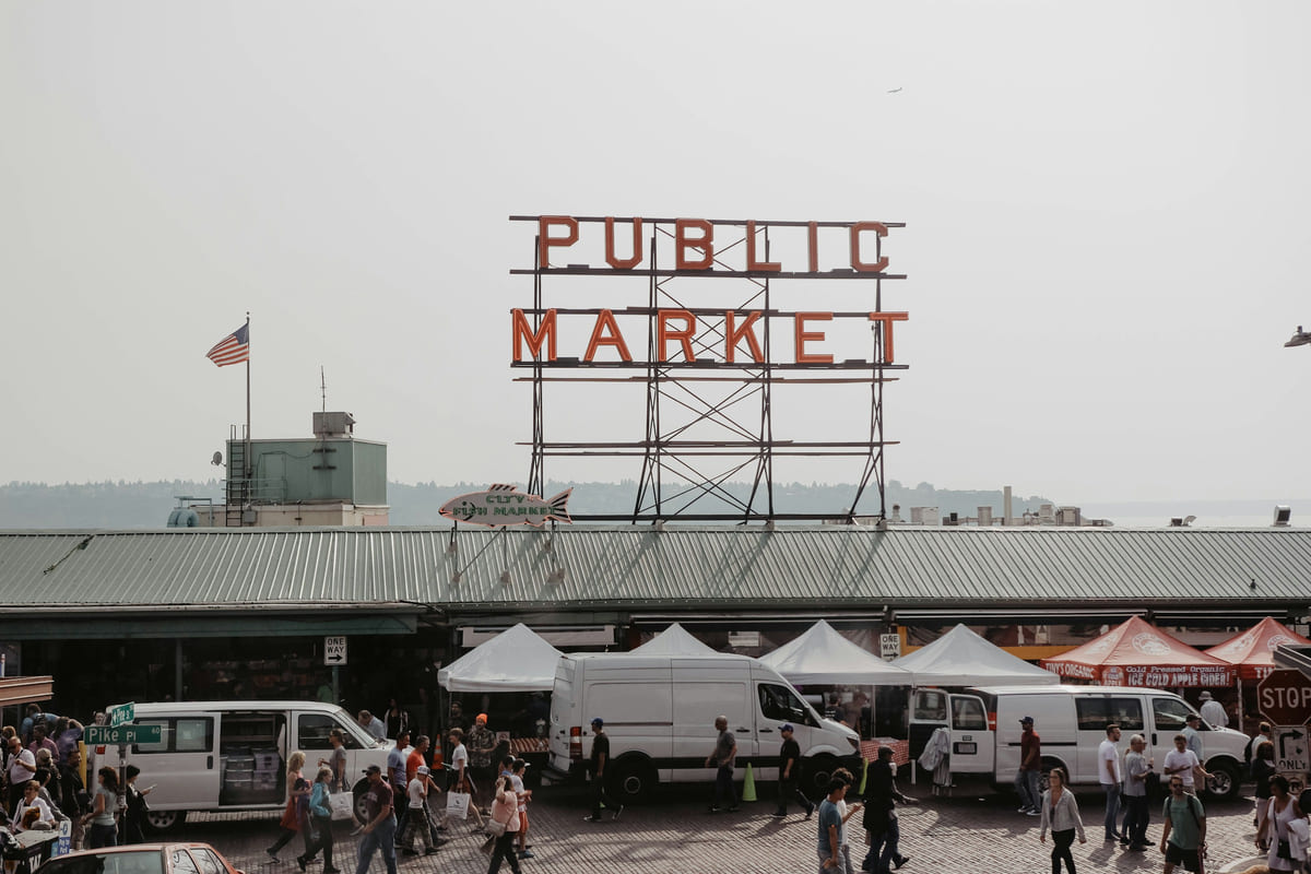 Shoppers and tents outside Pike Place Market in Seattle.
