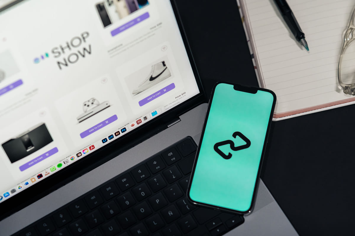 A smartphone beside a laptop displaying an online shop.